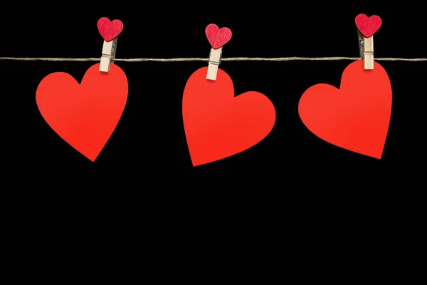 Три Красных Сердца Прикреплены Веревке Прищепками Черном Фоне Декор Виде — стоковое фото