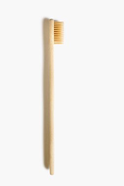 Wooden toothbrush on a white isolated background. Eco-friendly plastic-free toothbrush. Waste-free personal care products, dental care concept