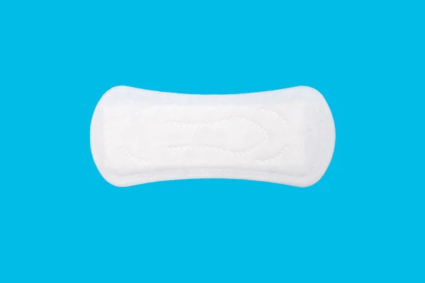 Feminine hygiene menstrual pad for the menstrual cycle on a blue background. Feminine hygiene product in the form of a sanitary napkin. A clean menstrual pad is positioned horizontally