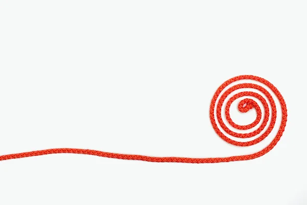 Una Corda Rossa Attorcigliata Giace Uno Sfondo Bianco Isolato Spazio — Foto Stock