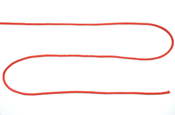 Red rope twisted in the form of a zigzag on a white isolated background. Red nylon rope lies on a white background, top view. Free space for text