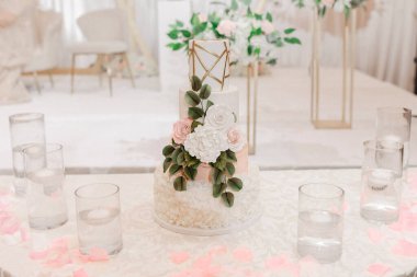 Çiçekler ve desenlerle süslenmiş düğün pastası. Gelin, damat ve misafirleri için güzel bir düğün pastası. Düğün partisi için pasta şeklinde şık ve lezzetli şekerlemeler.