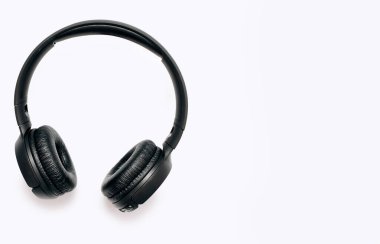 Overhead wireless Bluetooth headphones isolated on white background with free space for text. Close-up of black wireless headphones for playing games and listening to music tracks.
