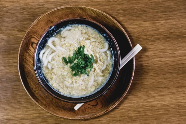 stock image Miso Ramen Asian noodles with egg and parsley in wooden bowl on brown rustic background.