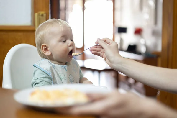 Mother Spoon Feeding Her Infant Baby Boy Child Sitting High — Stock Photo, Image