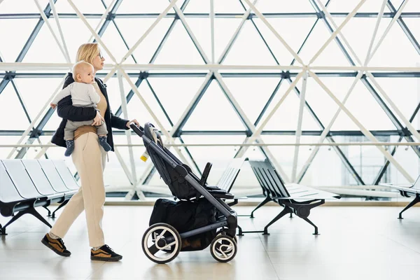 Mother Carying His Infant Baby Boy Child Pushing Stroller Airport —  Fotos de Stock