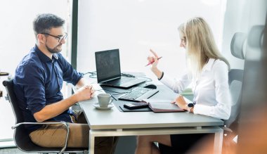 Business meeting. Client consulting. Confident business woman, real estate agent, financial advisor explaining details of project or financial product to client in office