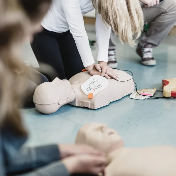 First Aid Cardiopulmonary Resuscitation Course Using Automated External Defibrillator Device Stock Photo