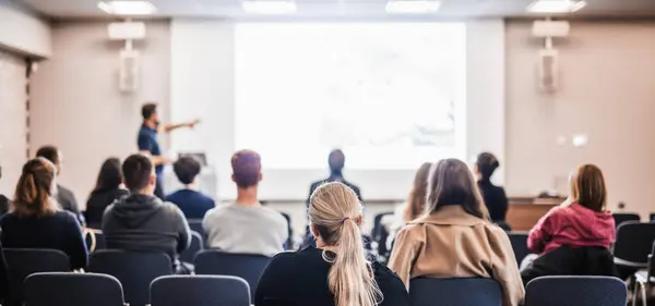 stock image Speaker giving a talk in conference hall at business event. Rear view of unrecognizable people in audience at the conference hall. Business and entrepreneurship concept