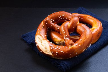 Food concept Homemade Soft Pretzels on black background with copy space clipart