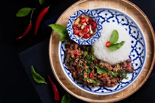 stock image Food concept Thai authentic Khao Pad kra pao rice with Thai Holy Basil beef  Stir-Fry on black background with copy space