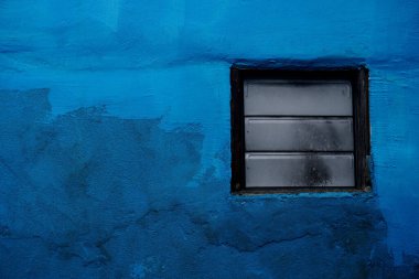 Mavi duvardaki AC üfleyici penceresi            