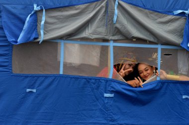 Tarakan - Indonesia, 8 October 2022 : Beautiful Indonesian traditional dancing girls wearing regional clothing from the Tidung tribe of North Kalimantan inside the blue tent clipart