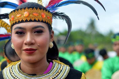 Tarakan - Indonesia, 8 October 2022 : Beautiful Indonesian traditional dancing girls wearing regional clothing from the Tidung tribe of North Kalimantan clipart