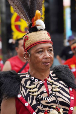 Tarakan - Indonesia, 7 October 2023 a man dressed in traditional Dayak clothing at a cultural parade clipart