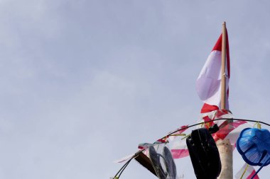 TARAKAN - İndonezya. 17 Ağustos 2023: Areca palmiye ağaçlarının tepesinde, tırmanış yarışmasını kazananlara verilen ödüller asılı