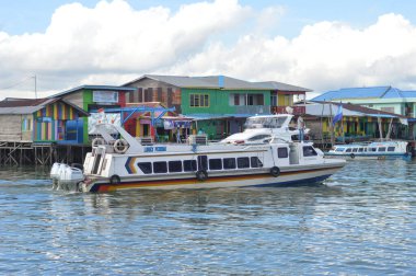 Tarakan - Indonesia, 29 March 2019 : Passenger speedboats are preparing to depart on inter-district routes in North Kalimantan clipart