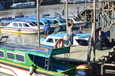 Tarakan - Indonesia, 9 April 2019 : regular passenger speedboats dock clipart