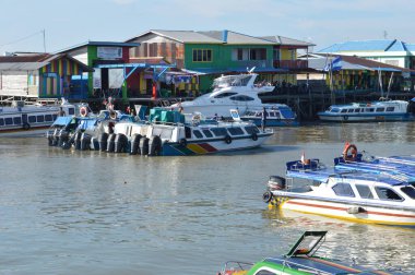 Tarakan - Indonesia, 9 April 2019 : regular passenger speedboats dock clipart