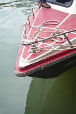 Boat bow with ropes floating on calm waters creates a tranquil scene for summer adventures, holidays, and peaceful relaxation.