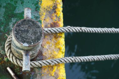 Dock cleat with mooring ropes, a symbol of nautical adventure and secure harbor life. Perfect for illustrating maritime themes and travel concepts.