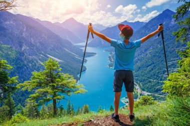 Hiker in the Alps. Boy backpacker tourist hiking at Lake. Alps, Bavaria, Germany