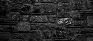 Türkiye 'nin Datca kentindeki dayanıklı siyah beyaz kesim taş duvar, arka planlar için iyi, pürüzsüz dizilmiş