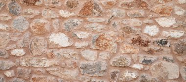 Datca, Türkiye 'de yapılmış sağlam mavi ve bej kesimli taş duvar, arka planlar için iyi, pürüzsüz dizilmiş