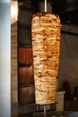 About street food in Turkey doner kebab is always preferable, chicken doner kebab in a restaurant in Istanbul Turkey                 clipart