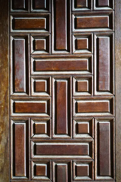 Old rotten wormy ancient oak door, old decorative wooden textured castle door