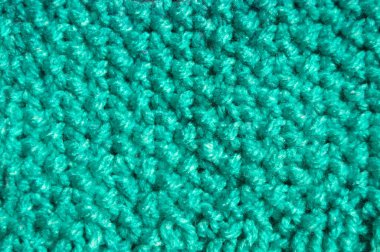 Pattern fabric made of wool. Handmade knitted fabric blue and turquoise wool background texture