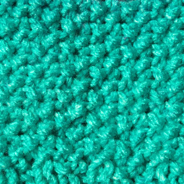 Pattern fabric made of wool. Handmade knitted fabric blue and turquoise wool background texture