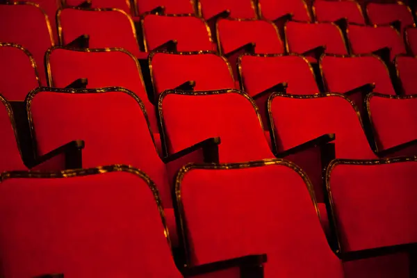 Modern cinema or theater hall empty and red comfortable seats, movie theater seats or chair