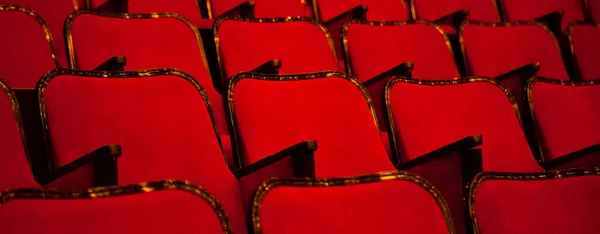 Modern cinema or theater hall empty and red comfortable seats, movie theater seats or chair