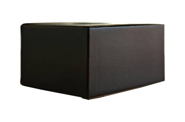 Closed black rectangular cardboard box with corrugated cardboard lid, on oak wooden table