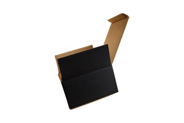 Closed black rectangular cardboard box with corrugated cardboard lid and hand on oak wooden table