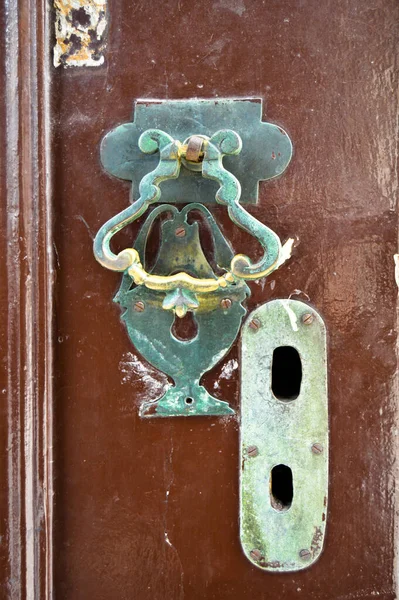 Decorative vintage old fashioned metal door knocker and keyhole, antique brown door handles Istanbul Turkey