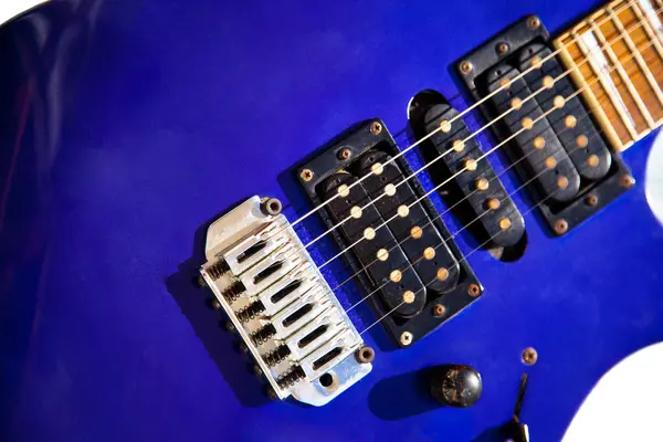 stock image Electric guitar bridge, strings and pickup, detail close-up view of guitar pickup in wood paint blue, stringed musical instrument