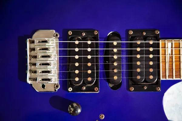 stock image Electric guitar bridge, strings and pickup, detail close-up view of guitar pickup in wood paint blue, stringed musical instrument