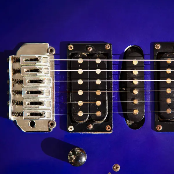 stock image Electric guitar bridge, strings and pickup, detail close-up view of guitar pickup in wood paint blue, stringed musical instrument