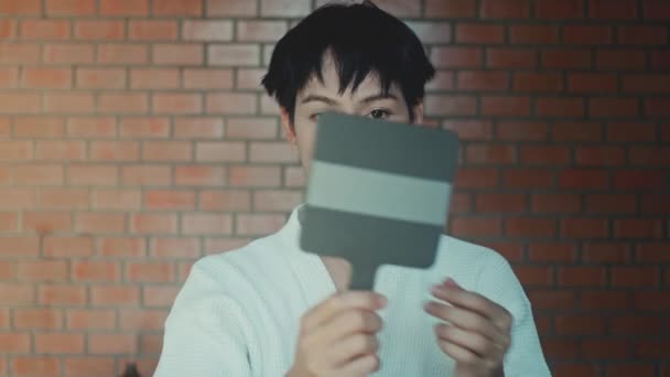 Young Asian Transgender Queer Man Does His Makeup His Room — Vídeo de stock