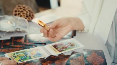 Falcı tarot kartları okuyor, bir müşteri için okuma yapıyor. Yakın çekim yavaş çekim.