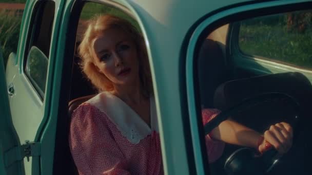Girl Pink Vintage Dress Sits Turquoise Colored Retro Car Backdrop — Vídeo de Stock