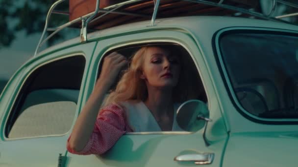 Girl Pink Vintage Dress Sits Turquoise Colored Retro Car Backdrop — Vídeo de stock