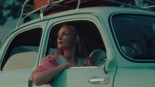 Girl Pink Vintage Dress Sits Turquoise Colored Retro Car Backdrop — Video