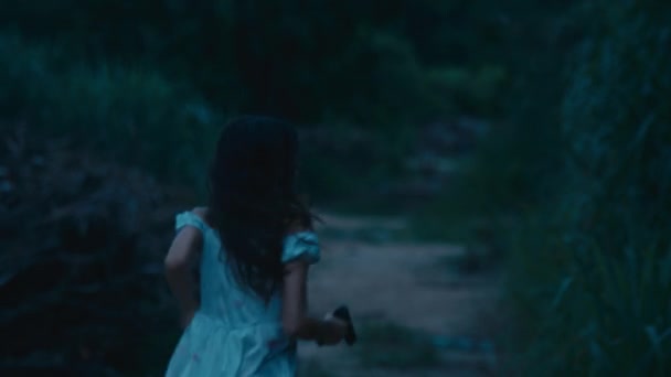 一个穿着血迹斑斑的衣服的吓坏了的女孩穿过树林从追捕她的人那里逃走了 黑魔法6K镜头 — 图库视频影像