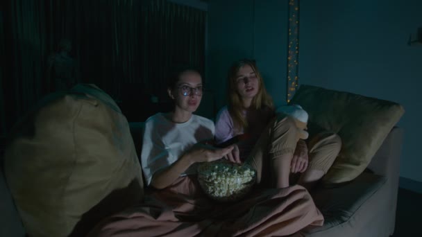 Two Young Women Sitting Eating Popcorn Pajamas Cozy Sofa Home — Stock Video