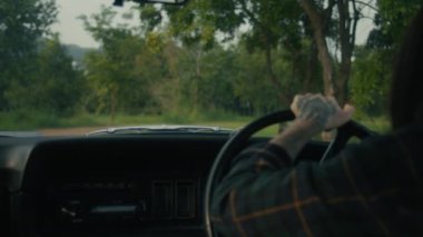 Kaputun altından çıkan dumanı gördükten sonra eski bir arabadan inen köylü kadını taksiden seyret. 