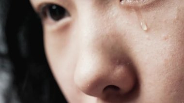 Ağlayan Gözlü Genç Asyalı Heterokromisi olan Yakın plan Çekimde Üzgün Görünen Kadın. Göz kapağı ve kirpiklerin altındaki göz bebeği ve göz bebeği. Kornea ve Retina ya da Soyut Kadın Kapalı Alan Mercekleri