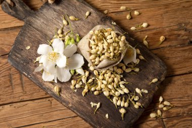 dry jasmine flower tea on bord